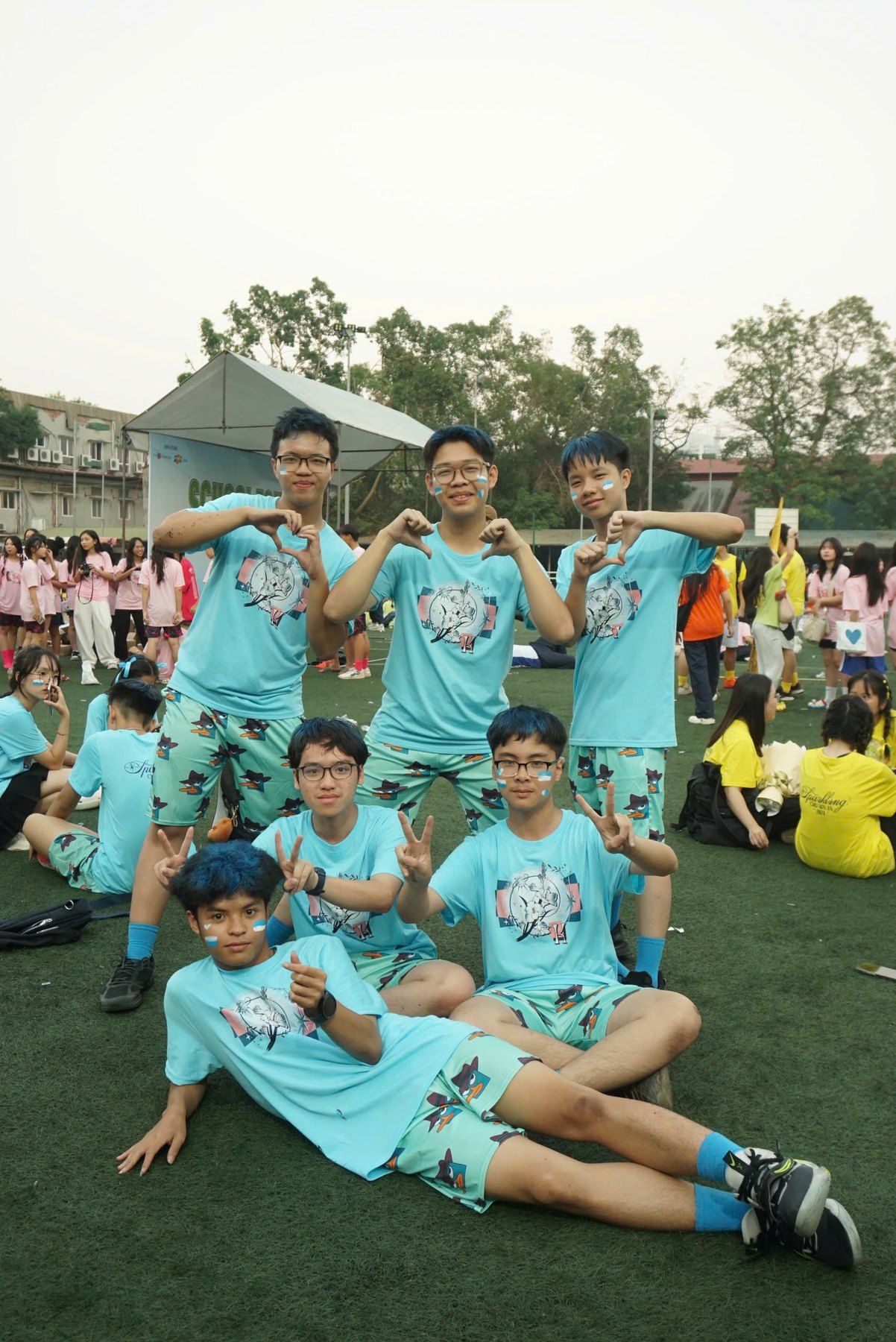 Cheerdance teammates in matching outfits posing on the field.