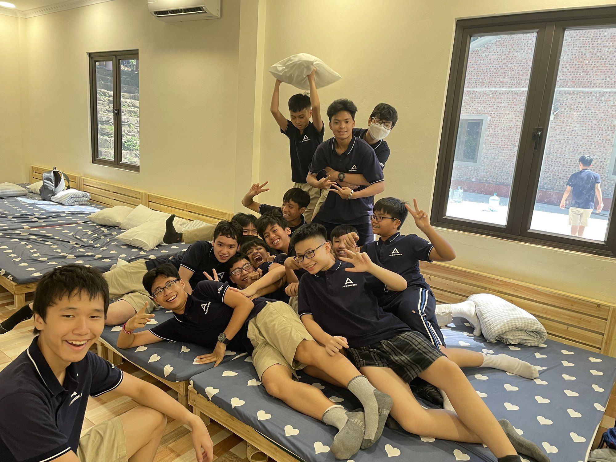 Archimedes Dong Anh School classmates laughing together in a dormitory.