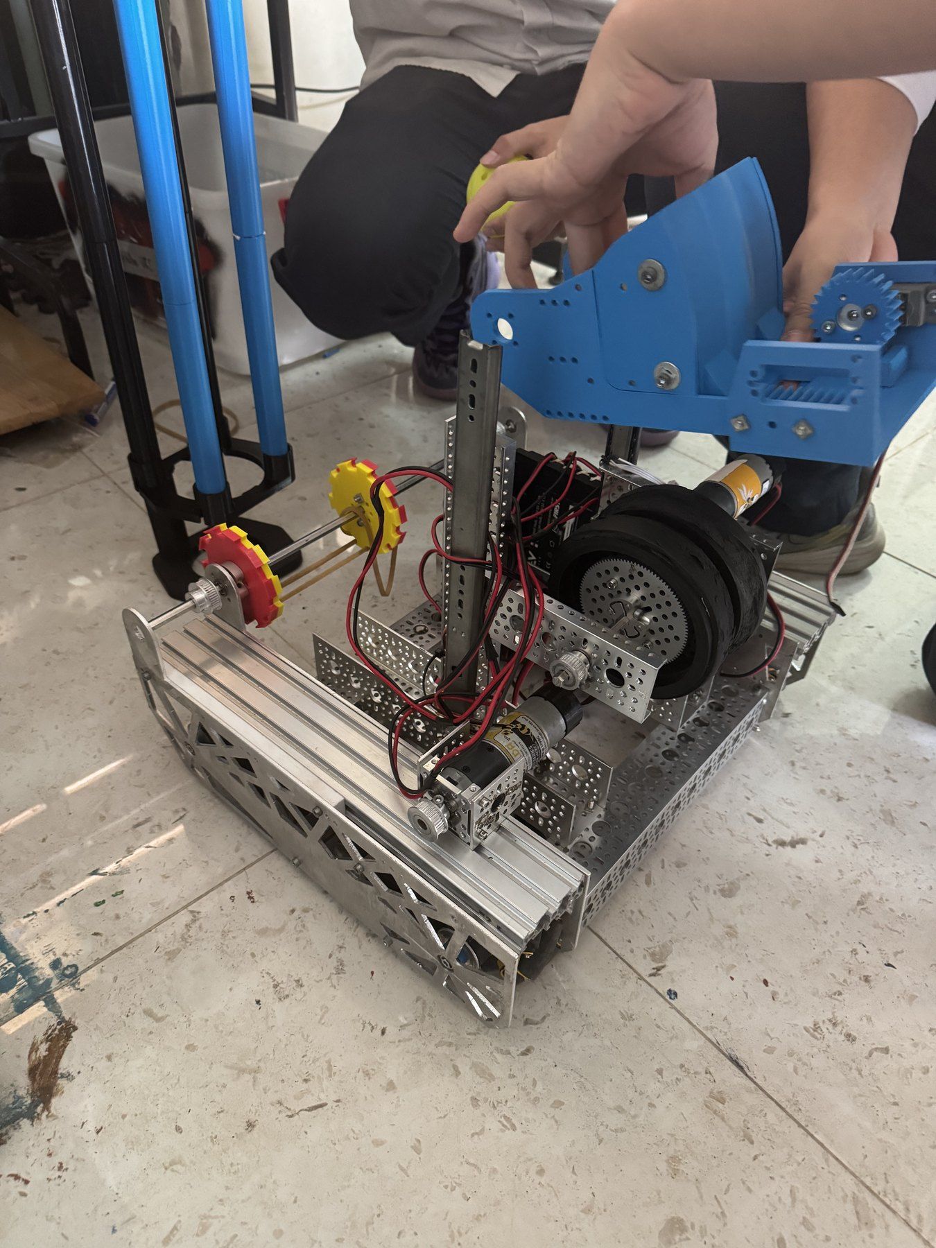Close-up of a wheeled prototype with blue 3D-printed parts.
