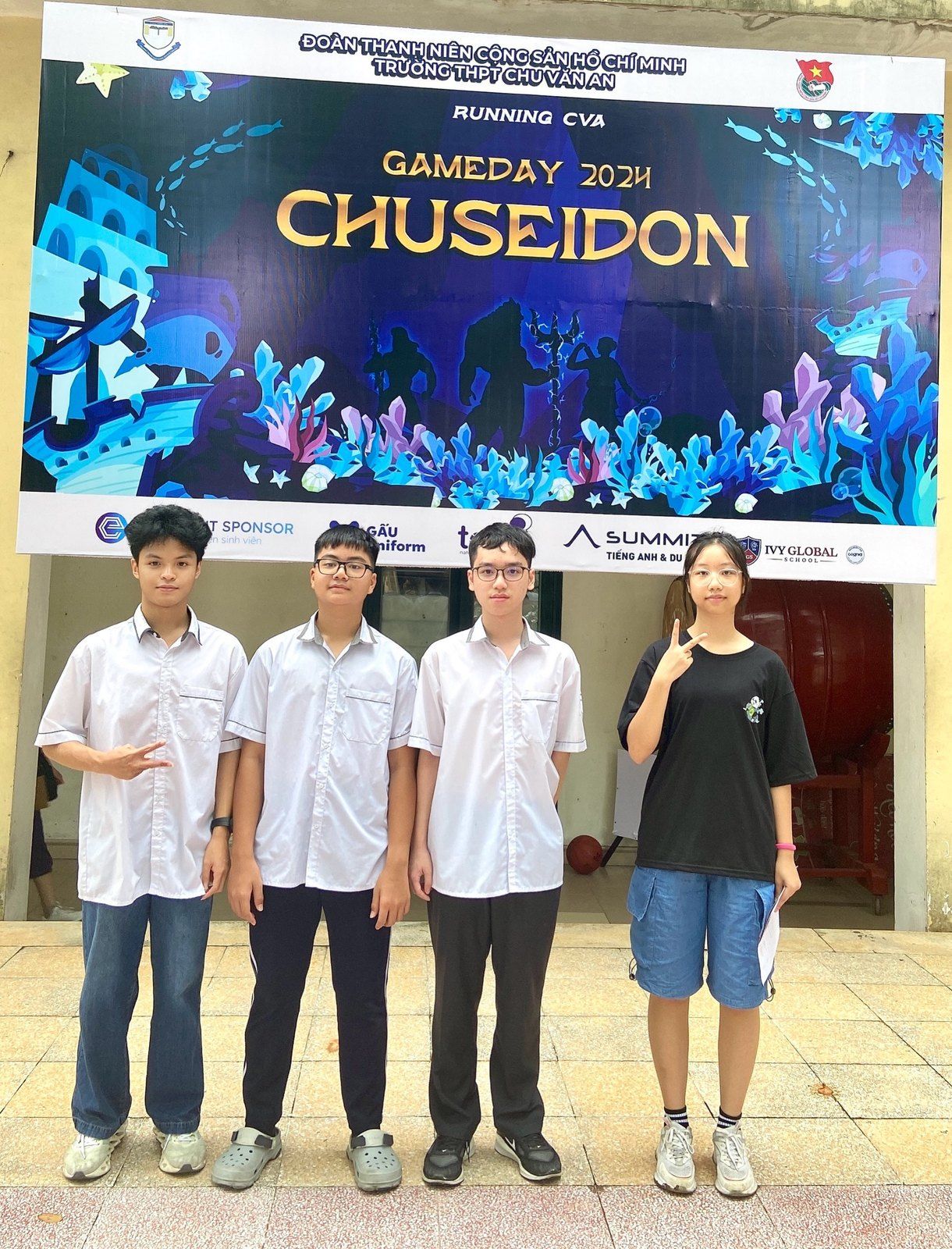 Four students in front of the Gameday 2024 Chuseidon backdrop.