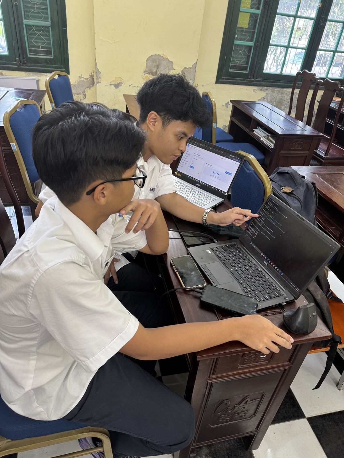 Students working on laptops in a classroom.